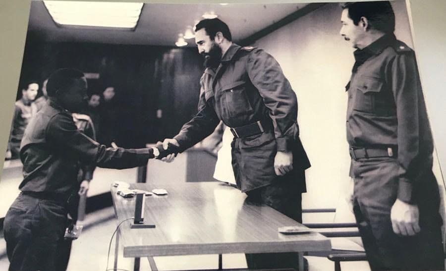 Figure 4. Victor Dreke accepting a military promotion from Fidel and Raul Castro.