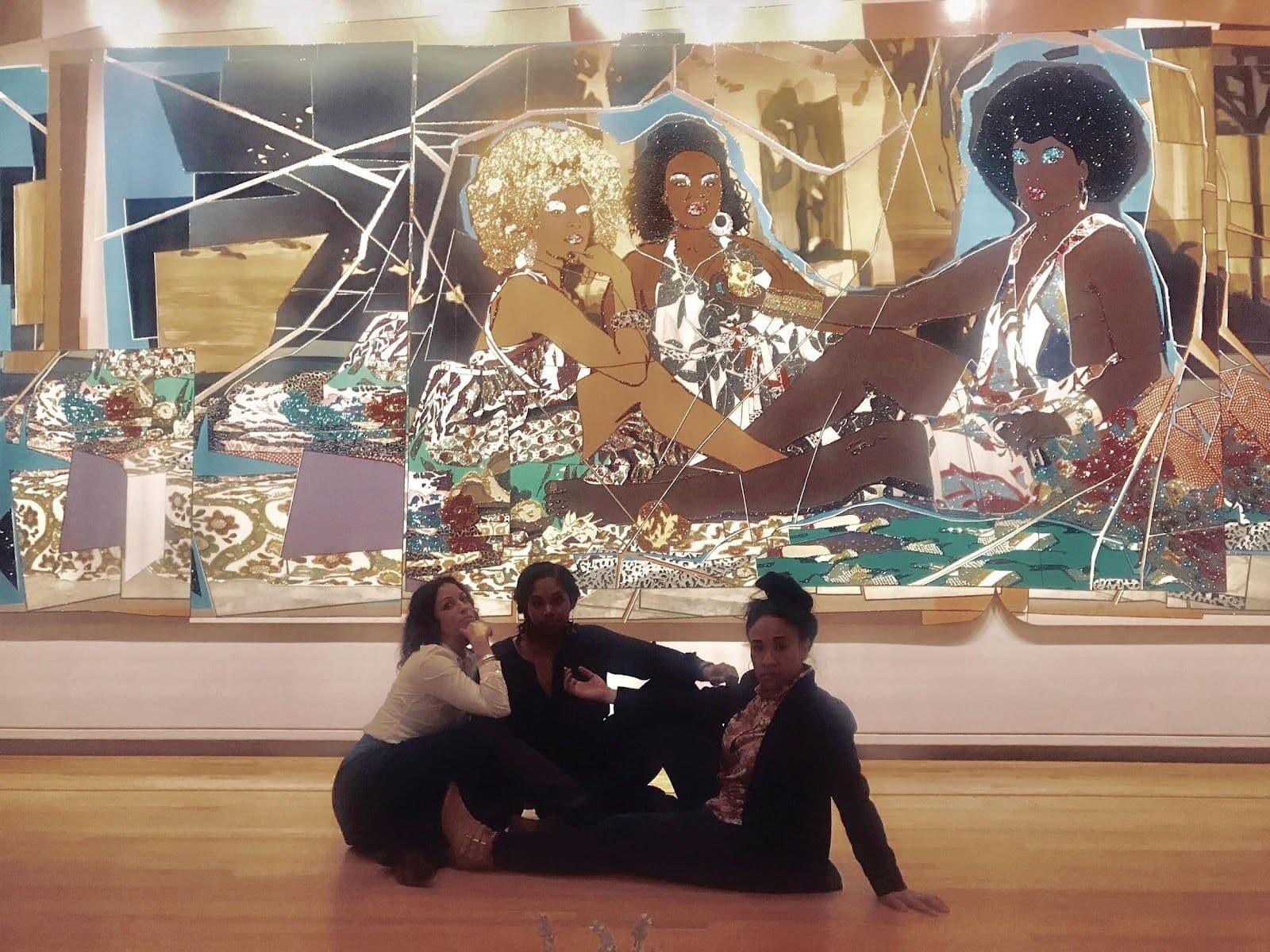 Figure 1. Vanessa, Joni, and Gloria seated in front of Mickalene Thomas’s “Le d,ejeuner sur l’herbe: Les trois femmes noires,” 2010.