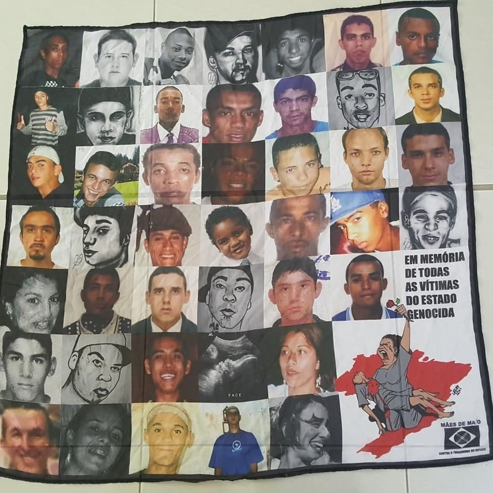 Figure 2. Mais de Maio banner for slain Brazilian youth and children of maternal activists killed by police, paramilitary, gangs, displayed on the floor of the 2018 trinational Brazil-Colombia-US meeting, mothers’ opening ceremony. Cali, Colombia, September 7, 2018. Photo by Joy James.